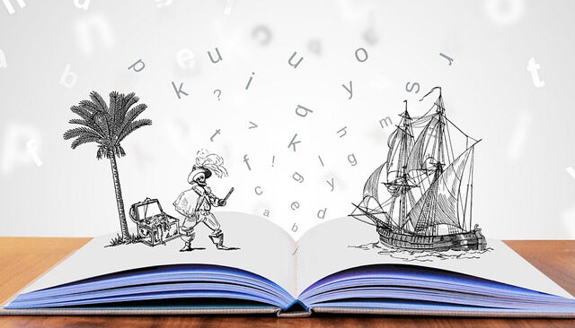 Buch auf Tisch mit visuellen Buchstaben und Illustrationen